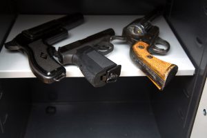 three pistols in the open safe